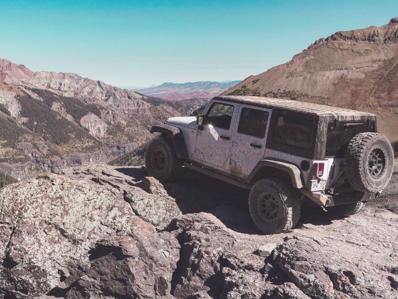 jeep wrangler on top of a mountain