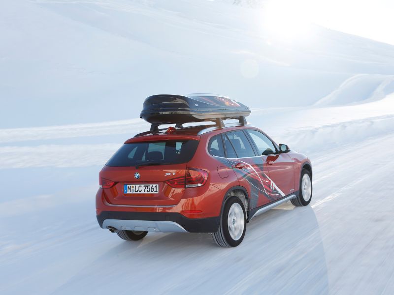 2012 red bmw x1 edition powder ride in an artic enviroment