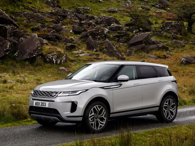 2020 land rover range rover evoque next to a typical british country side rock formation