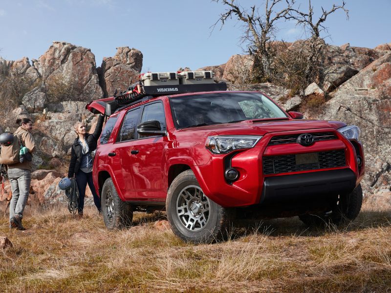 2020 red toyota 4runner venture edition in the bush close to a rock formation