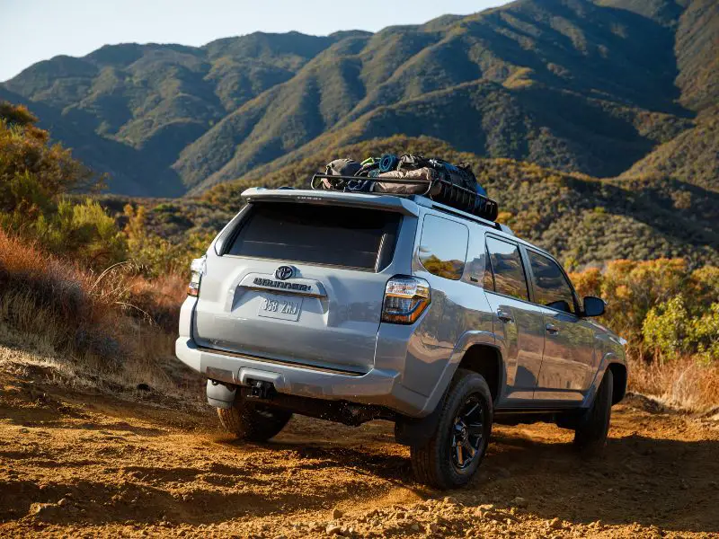 2021 flat grey toyota 4runner trail edition with factory roof rack driving down a mountain002.jpg