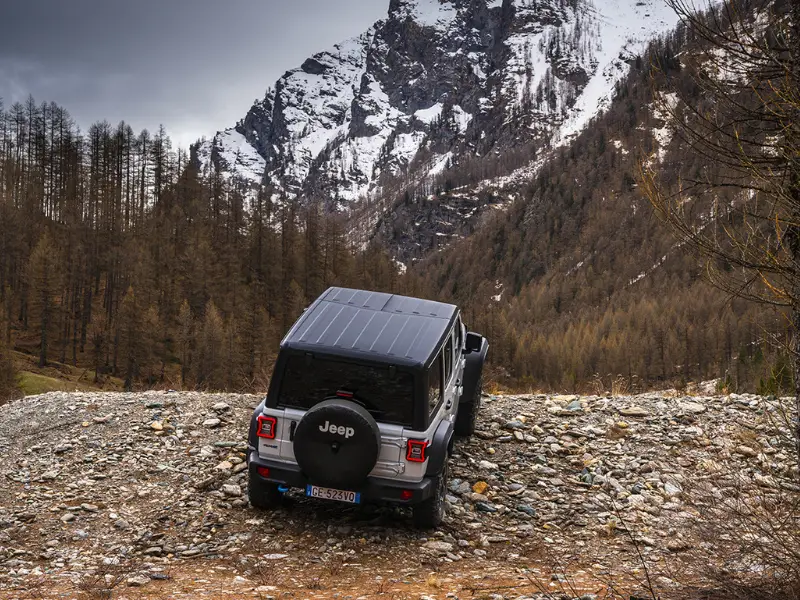 2023 silver jeep wrangler rubicon driving in a creek near the alps
