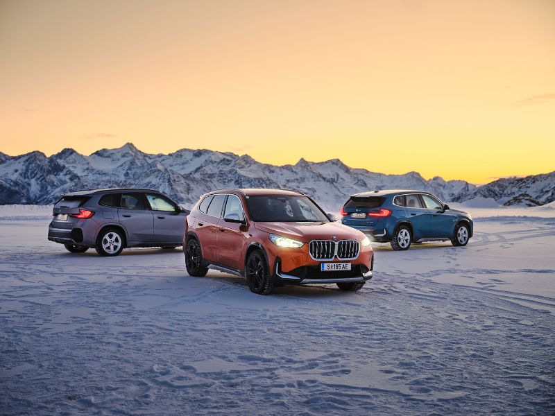 2023 silver orange and blue bmw x1 xdrive23d ix1 xdrive30 x1 xdrive30e standing in a snowy valley